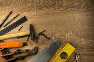 Hand tools lie on a wooden table photo