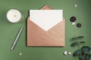 Blank white sheet of paper with an envelope green background photo