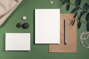 Blank white sheet of paper with an envelope green background photo