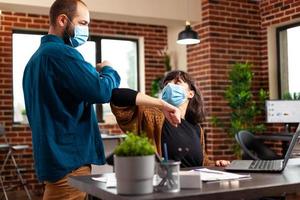 Workmates with medical protection face mask to prevent infection with covid19 photo