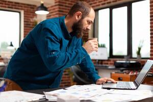 Businessman looking at computer screen analyzing marketing strategy photo