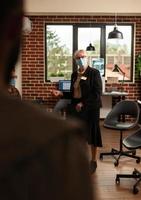 Close up of psychotherapist woman helping people at group therapy session photo