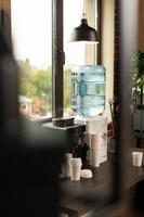 Close up of water dispenser on table in workplace at office photo