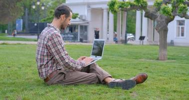 Freelancer at work outdoors in the park. photo