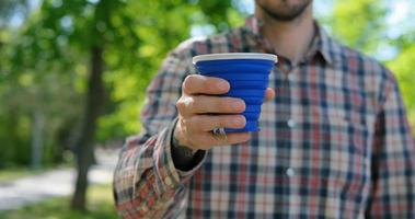 concepto de desperdicio cero, uso masculino joven taza de café reutilizable foto