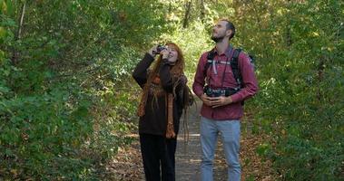 couple of travelers  in autumn forest photo