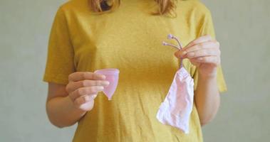 Close up of menstrual cup in woman hands. Zero waste and eco friendly concept photo