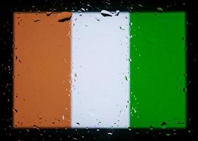 Drops of water on Cote d'Ivoire flag background. Shallow depth of field. Selective focus. Toned. photo