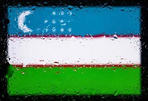 Drops of water on uzbekistan flag background. Shallow depth of field. Selective focus. Toned. photo