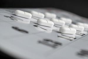 White tablets round shape on a calendar sheet photo