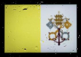 Drops of water on Vatican flag background. Shallow depth of field. Selective focus. Toned. photo