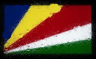 Drops of water on seychelles flag background. Shallow depth of field. Selective focus. Toned. photo