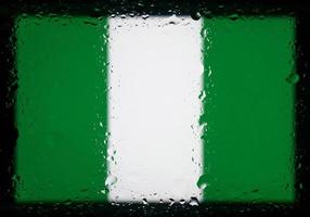 Drops of water on Nigeria flag background. Shallow depth of field. Selective focus. Toned. photo