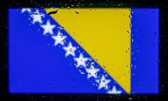 Drops of water on Bosnia and Herzegovina flag background. Shallow depth of field. Selective focus. Toned. photo