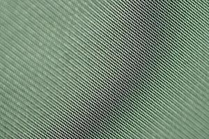 Green matte background of linen fabric, closeup. Cloth texture .Abstract green background. photo