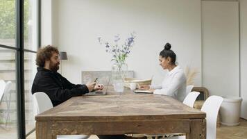 Woman and man sitting at table having conversation video