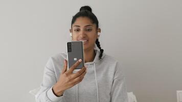 Woman having video call with smartphone