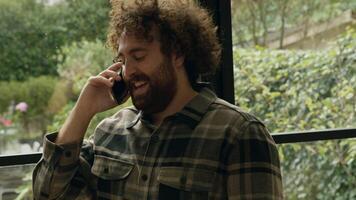 Man calling with smartphone standing in room and going outside video