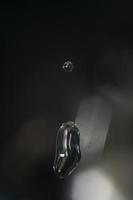 A drop of water falling. Macro. Bokeh, dark color. photo