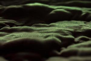 Shiny fabric texture with shadows. Abstract green wallpaper. photo