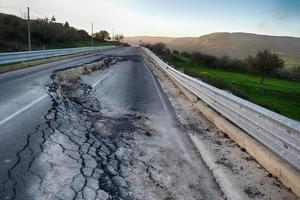 Asphalt road destroyed by the landslide photo