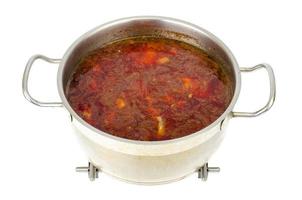 Saucepan with vegetable beetroot soup on white background. photo