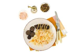 Black sausage with sauerkraut on plate. Studio Photo. photo