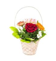 Wicker decorative basket with bouquet of beautiful flowers isolated on white background photo
