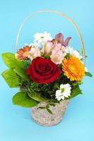 Bouquet of bright beautiful flowers on blue background photo