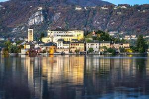 Winter early sunrise panorama of Orta San Giulio island, in the same name lake, Piedmont, Northern Italy. Small lake of alpine origin, is UNESCO Site and home of a cloistered nuns convent.