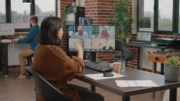 Employee using video call on computer to talk to workmates