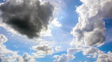 Blue sky with white plump fluffy clouds and sun. Cumulus clouds. Nature weather blue sky. Beautiful background white clouds. photo