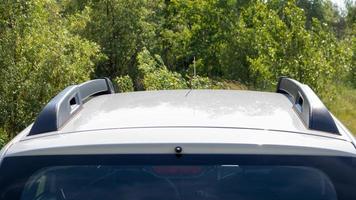 A station wagon roof rack for securing large loads or a cargo box. Travelling by car. Part installed on the roof of the vehicle. photo