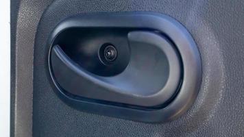 The car is inside. Closeup of car door handle, car door inside. Inner plastic car door handle. photo