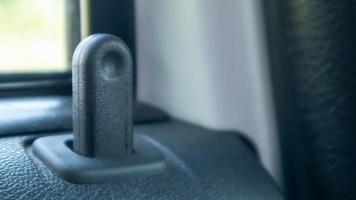 Close the lock button for the interior door of the vehicle. Door lock button inside the car interior close-up. photo