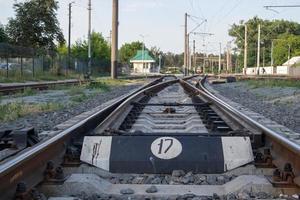 Abstract view of railway arrows. A turnout switch for rails in railway traffic. Rails, sleepers and crushed stone on the railway track. Switching transitions. photo