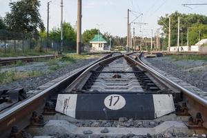 Abstract view of railway arrows. A turnout switch for rails in railway traffic. Rails, sleepers and crushed stone on the railway track. Switching transitions. photo