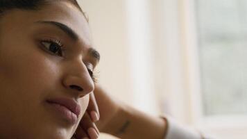 Close up of woman watching screen and looking contemplative video