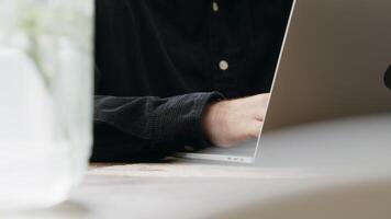 Close up of gesturing and typing hands of man with laptop video