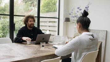 Woman and man sitting at table having conversation video