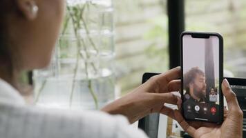 Woman having video call on smartphone with man