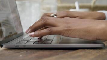 Close up of fingers of woman typing on laptop video