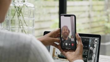 Talking woman has video call on smartphone with man