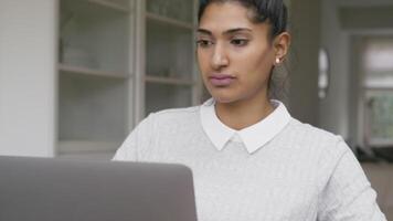 Woman typing on laptop and watching screen video