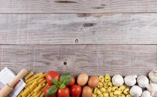 pasta, vegetables, eggs, on wooden board, ingredients for Italian restaurant