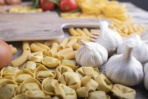 pasta set, vegetables, garlic, italian restaurant ingredients, cutting board photo