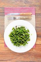 Green Beans Fried with Garlic on a White Plate.