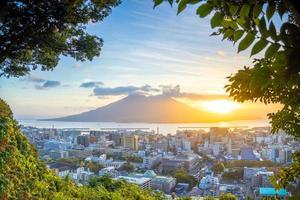 Kagoshima city downtown skyline cityscape  with Sakurajima Volcano in Kyushu, Japan photo