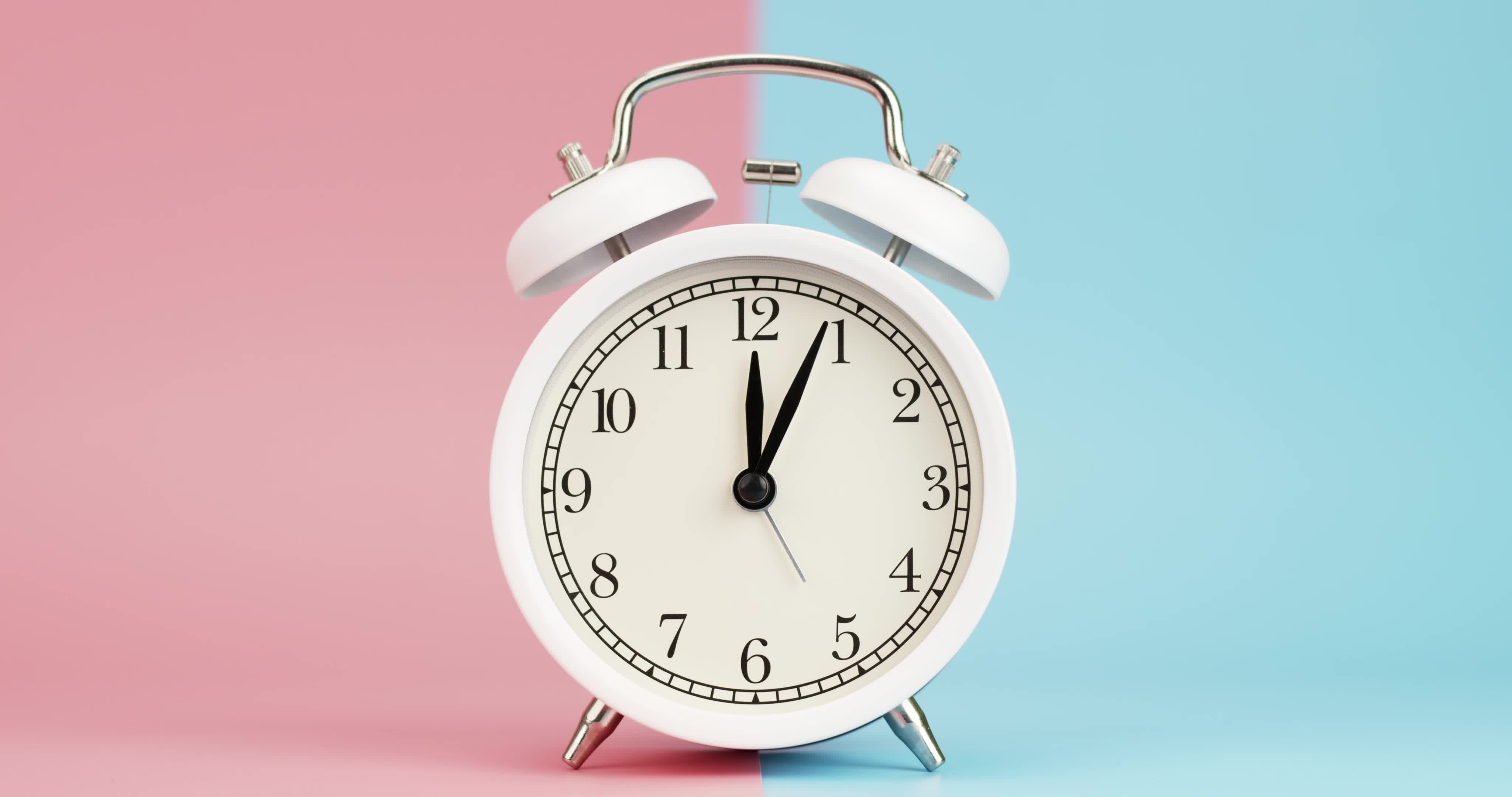 Alarm clock isolated on a pink blue background, Showtime 12.00 am or pm