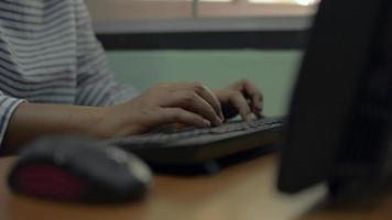 Business woman typing computer keyboard and using wireless mouse on the desk at home. video